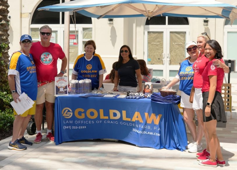 GOLDLAW Celebrates International Red Sneakers Day