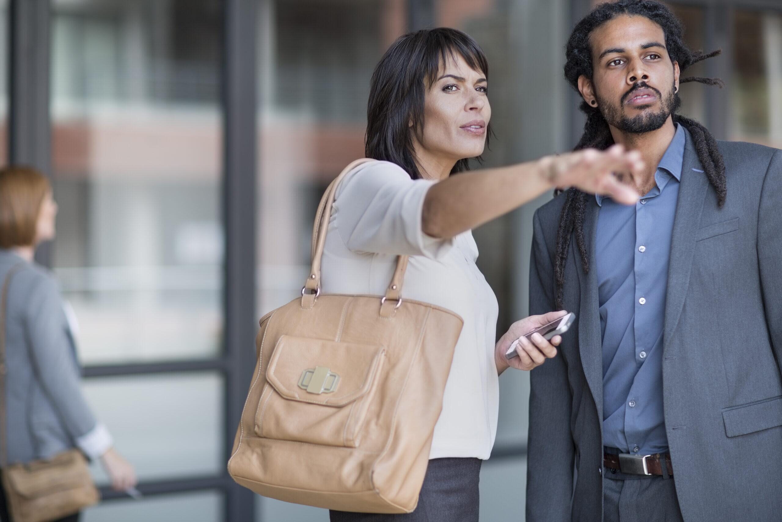 Travelling businessman asking woman for directions